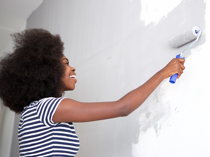 woman painting the wall